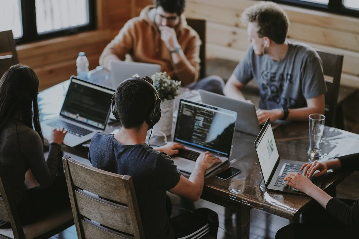 Team collaborating together around a table in a workshop setting